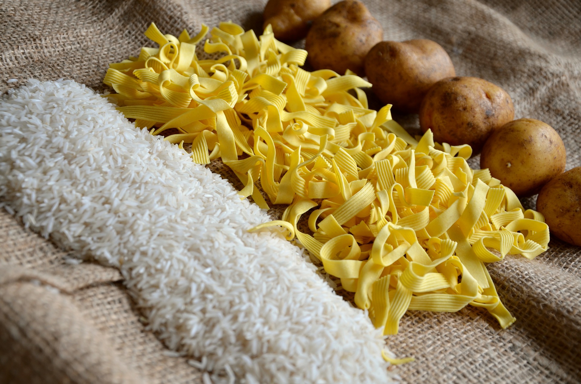 Photograph of rice, noodles and potatoes. The curry kit mentioned in this article may be used with any of these.